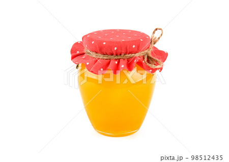 Golden honey in jar isolated on white . Golden honey in jar isolated on white . 98512435