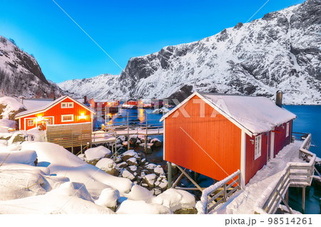 Fabulous evening seascape of Norwegian sea and cityscape of Nusfjord village. Fabulous evening seascape of Norwegian sea and cityscape of Nusfjord village. 98514261