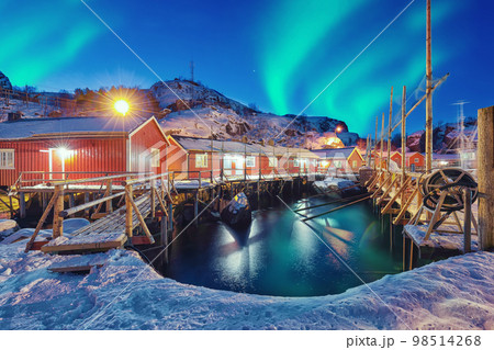 Fabulous evening seascape of Norwegian sea and cityscape of Nusfjord village with Northern Lights Fabulous evening seascape of Norwegian sea and cityscape of Nusfjord village with Northern Lights 98514268