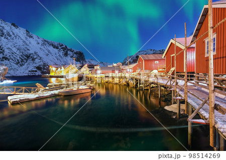 Fabulous evening  seascape of Norwegian sea and cityscape of Nusfjord village with Northern Lights 98514269