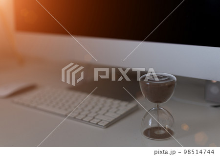 Hourglass on laptop keyboard. Time management concept 98514744