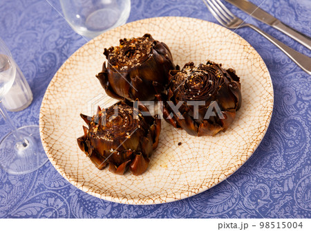 Top view of vegetarian appetizer of baked artichokes served on plate 98515004