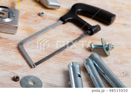 Hacksaw among various construction tools 98515050