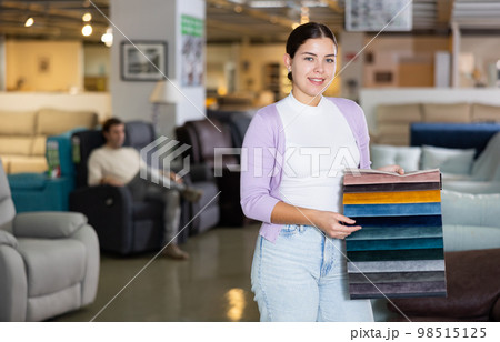 Portrait of woman presenting upholstery samples 98515125