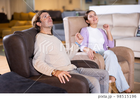 Happy couple choose a new armchair Happy couple choose a new armchair 98515196