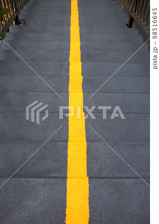 Yellow line on stairs of the overpass. Top view Yellow line on stairs of the overpass. Top view 98516645