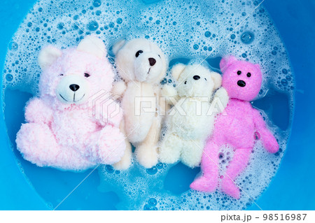 Soak toy teddy bears in laundry detergent water dissolution before washing.  Laundry concept, Top view 98516987