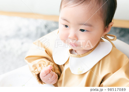 離乳食を手づかみ食べするカミカミ期の赤ちゃん 98517089
