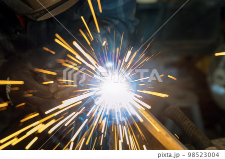 Using semiautomatic argon gas shielded welding semi-automatic machine worker works welding metal 98523004