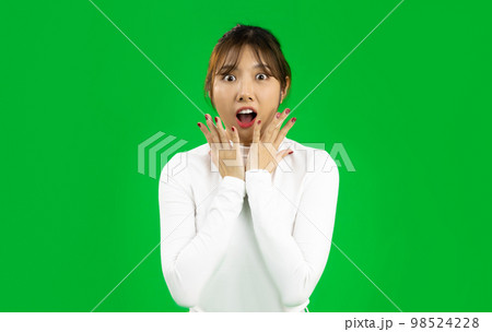 Young Asian woman eith surprised face isolated on green screen. Young Asian woman eith surprised face isolated on green screen. 98524228