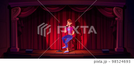 Comedian girl with mic on stage 98524693