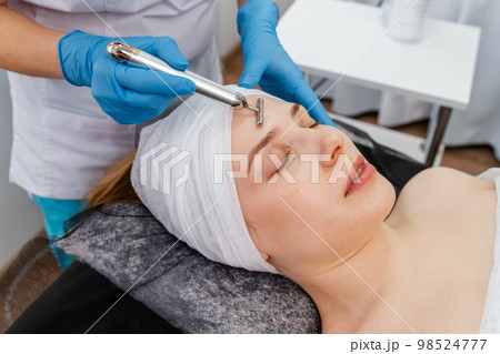 Special electric equipment for skincare. Girl in beauty wellness salon 98524777