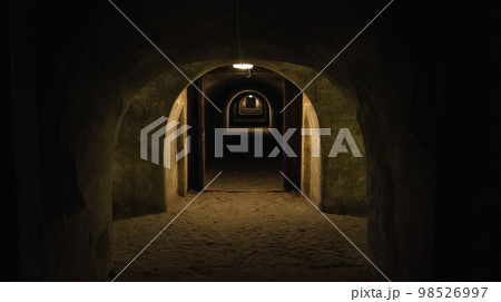 First person view walking through the military tunnel in the dungeon. Defensive structure, casemates. Bomb shelter during the war. Copy space for text 98526997
