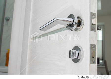 Broken doorknob in interior door. Poor quality door hardware, close-up Broken doorknob in interior door. Poor quality door hardware, close-up 98527089