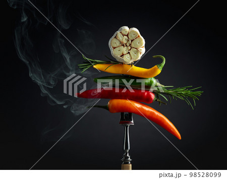 Red hot chili peppers with garlic and rosemary on black background. 98528099