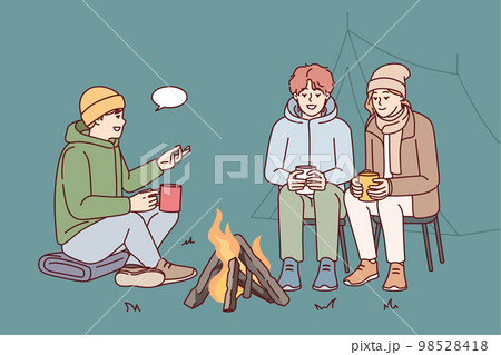 Young people communicate while sitting around campfire during camping trip in nature. Vector image 98528418