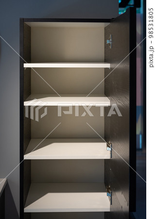 a empty black and white cabinet wood in modern and minimal style in front of wall in the restroom. 98531805