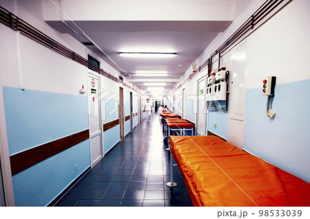 Long hospital corridor with gurneys without people. Long hospital corridor with gurneys without people. 98533039