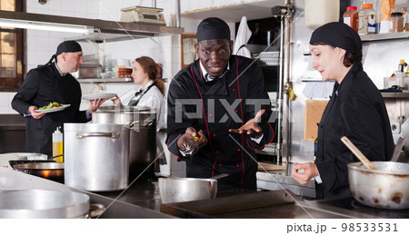 Chef male dissatisfied with the work of girl helper Chef male dissatisfied with the work of girl helper 98533531
