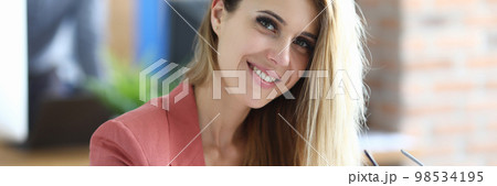 Portrait of a beautiful smiling businesswoman in workplace. 98534195