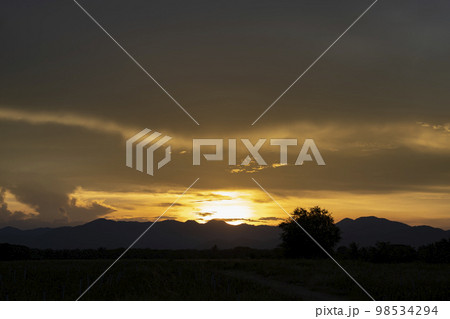 Senset moment view behind the mountain in the golden light from the sun. 98534294
