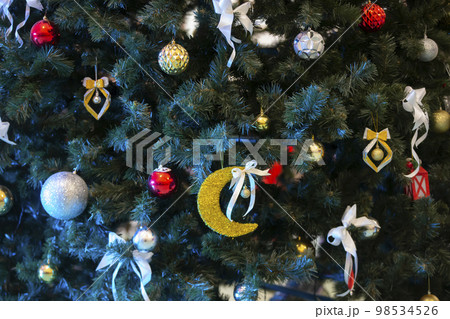 Part of a Christmas tree decorated with colorful toys. Part of a Christmas tree decorated with colorful toys. 98534526
