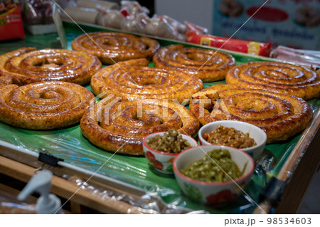 Sai Aua, Northern Thailand Spicy Sausage is a famous Traditional Local saurage cooked with curry and herb, lay on shop and ready for sales. Sai Aua, Northern Thailand Spicy Sausage is a famous Traditional Local saurage cooked with curry and herb, lay on shop and ready for sales. 98534603