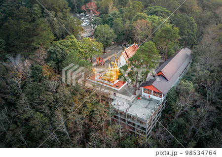 Wat Phra That Doi Tung from above birdeyes view, a famous Temple and Buddhism place. It's settled on the mountain in Chiang Rai province, north of Thailand. 98534764