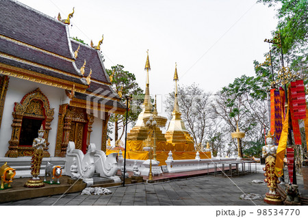 Wat Phra That Doi Tung, famous temple north of Thailand. Thai Wording at center-bottom of image that left side means PLEASE TAKE OFF YOUR SHOES and right side means LADY NO ENTRY. 98534770
