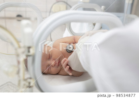 A newborn baby lies in boxes in the hospital. A child in an incubator. Neonatal and Premature Intensive Care Unit 98534877