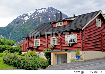 Wooden house in village countryside rocky hills - Andalsnes - Norway 98538104