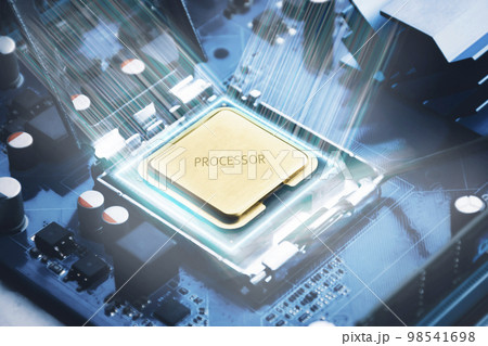 Golden CPU chip in a slot on a computer motherboard and glowing light around the processor chip 98541698