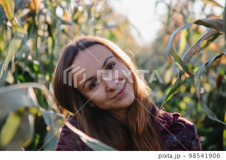 Woman smiles enjoying exploration of corn plantations 98541906