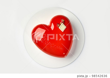 Heart shaped mousse cake with glossy red icing Heart shaped mousse cake with glossy red icing 98542636