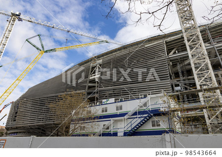Santiago Bernabeu. Exterior of the Santiago Bernabeu stadium in full works and renovation of the venue where Real Madrid C.F. Football field. Field full of machines. MADRID, SPAIN - JANUARY 24, 2023. Santiago Bernabeu. Exterior of the Santiago Bernabeu stadium in full works and renovation of the venue where Real Madrid C.F. Football field. Field full of machines. MADRID, SPAIN - JANUARY 24, 2023. 98543664