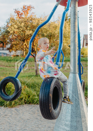Funny cute happy baby playing on the playground. The emotion of happiness, fun, joy. Smile of a child. boy playing on the playground 98543925