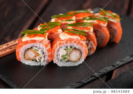 Sushi roll philadelphia with crab and cucumber and cream cheese, caviar on black background close-up. Sushi menu. Japanese food concept 98543989