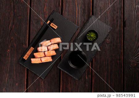 Sushi roll philadelphia with crab and cucumber and cream cheese, caviar on black background top view. Sushi menu. Japanese food concept 98543991