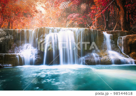 Waterfall flowing in autumn tropical rainforest at national park 98544618