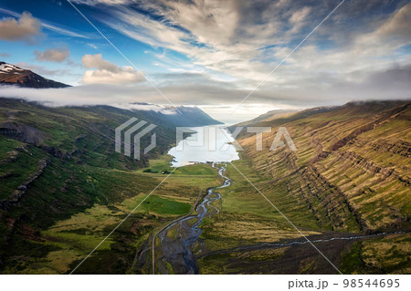 Mjoifjordur peninsula fjord mountain and tiny village on coastline in summer at Iceland 98544695