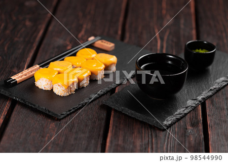 Sushi roll with cheese with chopsticks - asian Japanese food concept Sushi roll with cheese with chopsticks - asian Japanese food concept 98544990