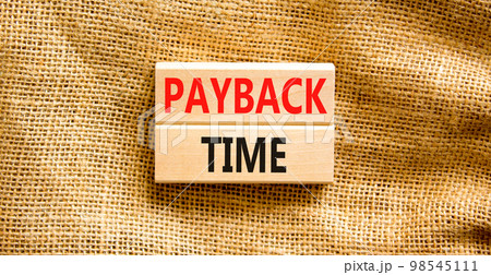 Payback time symbol. Concept words Payback time on wooden blocks. Beautiful canvas table canvas background. Business and payback time concept. Copy space. Payback time symbol. Concept words Payback time on wooden blocks. Beautiful canvas table canvas background. Business and payback time concept. Copy space. 98545111