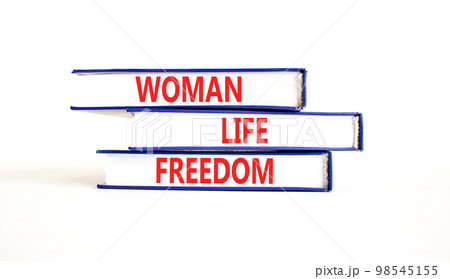 Woman life freedom symbol. Concept words Woman Life Freedom on books on a beautiful white table white background. Social issue woman life freedom concept. Copy space. 98545155