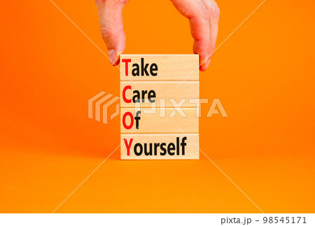 TCOY take care of yourself symbol. Concept words TCOY take care of yourself on wooden block on beautiful orange table orange background. Business TCOY take care of yourself concept. Copy space. TCOY take care of yourself symbol. Concept words TCOY take care of yourself on wooden block on beautiful orange table orange background. Business TCOY take care of yourself concept. Copy space. 98545171