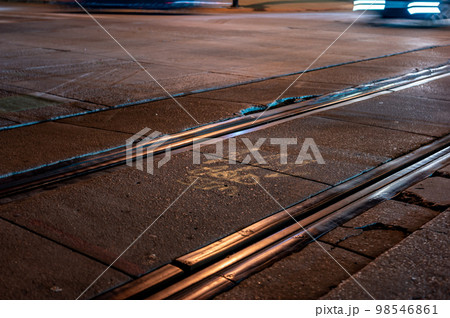 Street level selective focus on trolley rail lines at night in San Diego. 98546861
