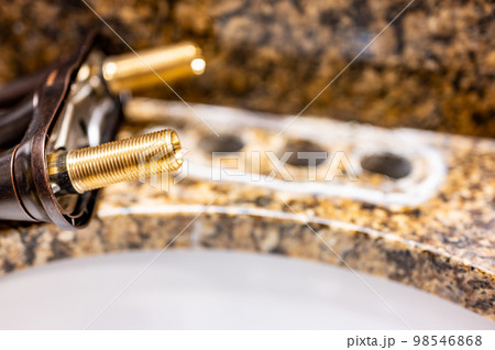 Replacing a bathroom sink faucet with a new assembly. Replacing a bathroom sink faucet with a new assembly. 98546868