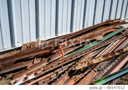 Pile of rusted steel fence posts on the ground Pile of rusted steel fence posts on the ground 98547012
