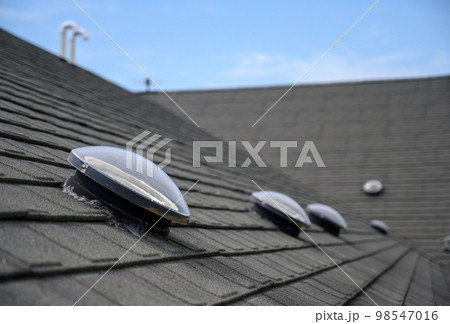 Dome shaped solar tube skylight on asphalt shingle roof  98547016