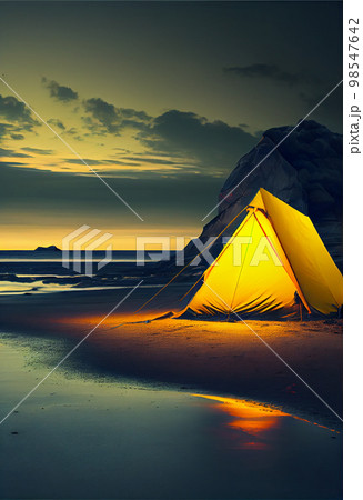 Illuminated yellow tent wild camping in the mountains under night sky Illuminated yellow tent wild camping in the mountains under night sky 98547642