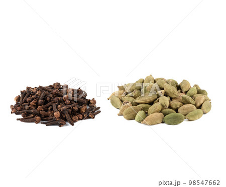 Culinary seasonings cardamom and cloves on a white background. Culinary seasonings cardamom and cloves on a white background. 98547662